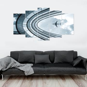 Airplane Flying Over Building Airplane Canvas Wall Art