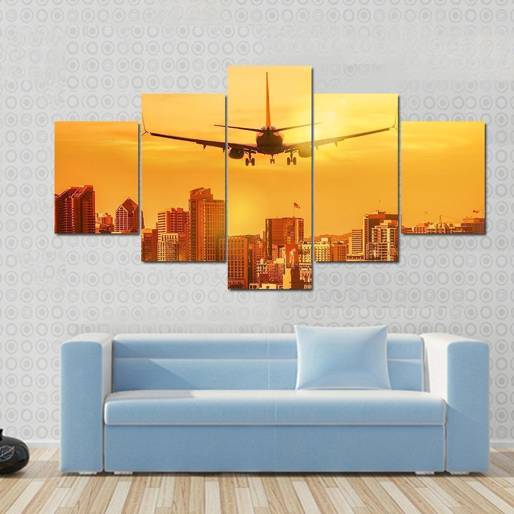 Airplane Flying Towards Big City Airplane Canvas Wall Art